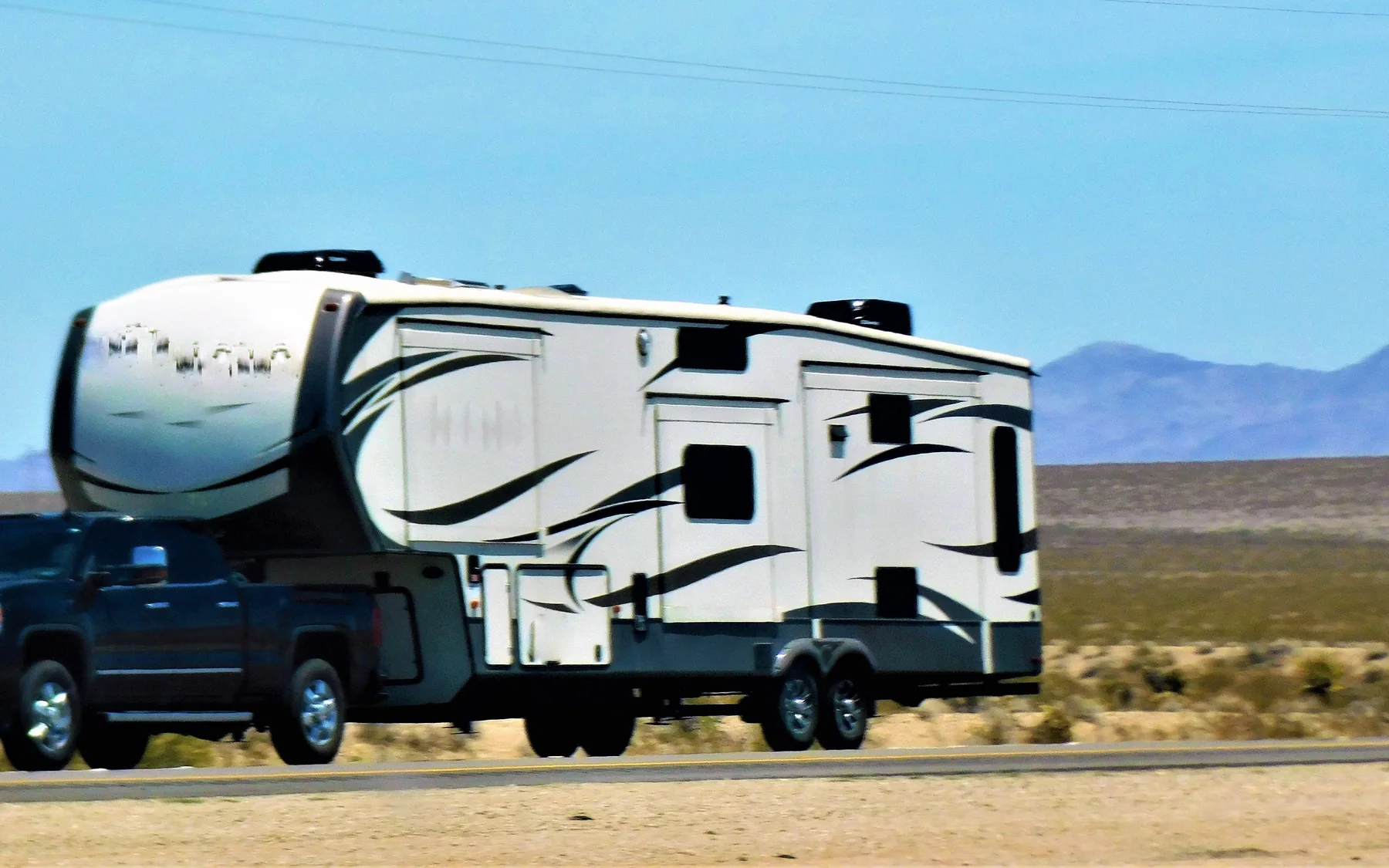 RV Service in White City Travel trailer in regional mountain scenery